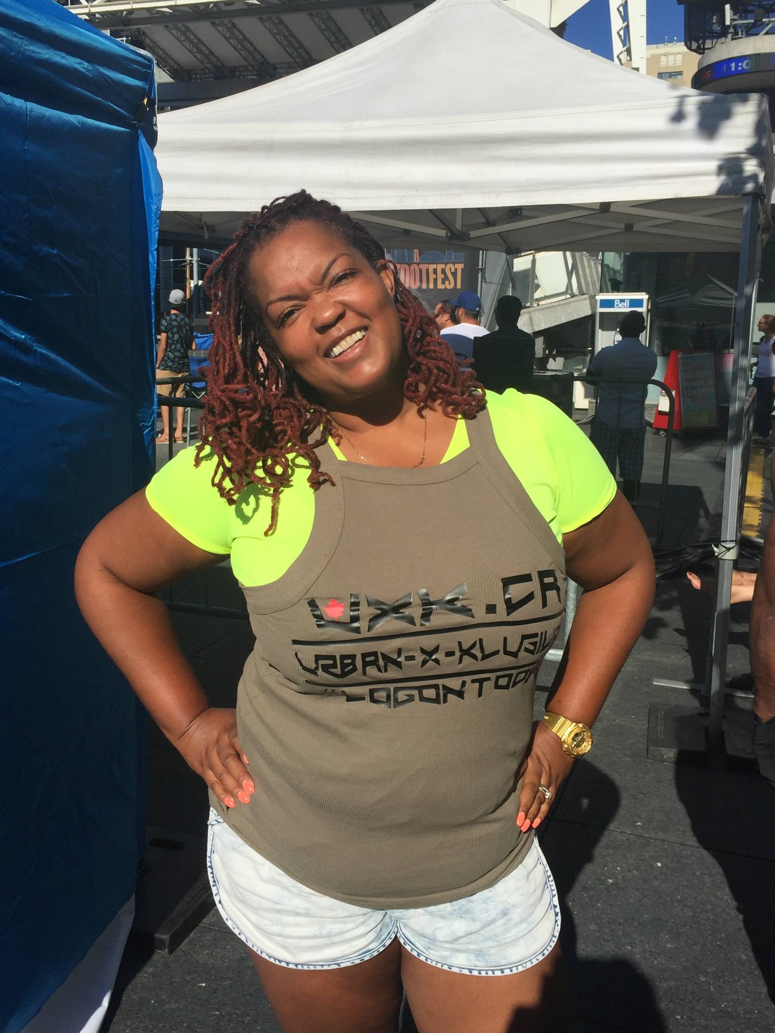Woman at a festival wearing a UXK.CA tank top