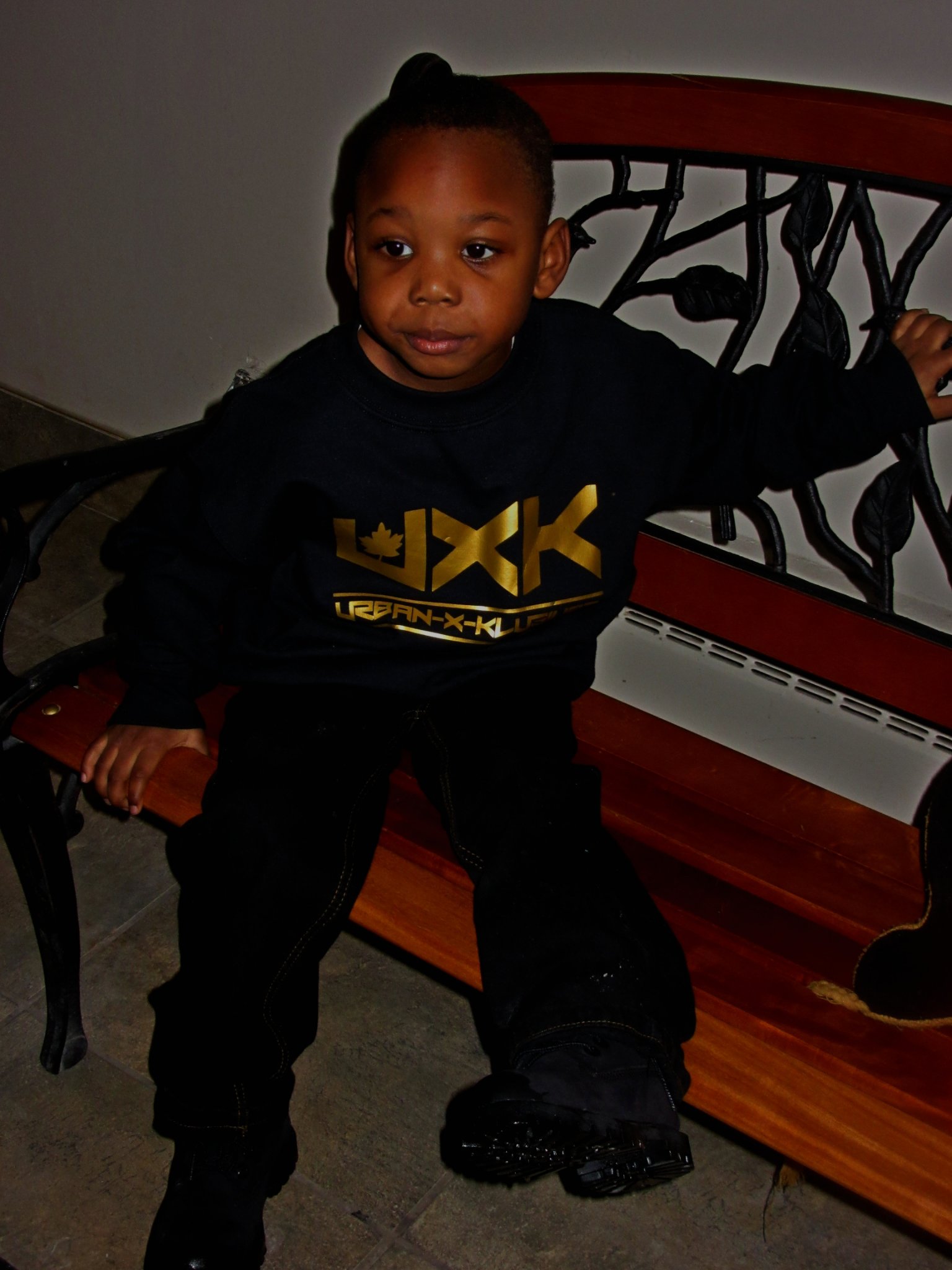 Trav's son wearing a black and gold UXK longsleeve